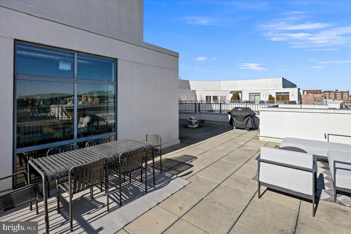 2020 12th Street Northwest, Unit 812 Washington, DC 20009 - Photo 31 of 38 a view of a terrace with furniture and stove