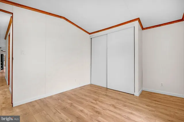 a view of a room with wooden floor