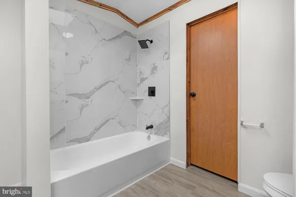 a bathroom with a bathtub and shower