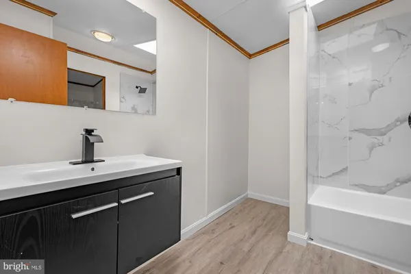 a view of a bathroom with a sink mirror and bathtub