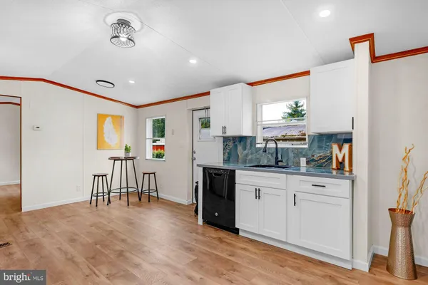 a kitchen with a refrigerator and a stove top oven
