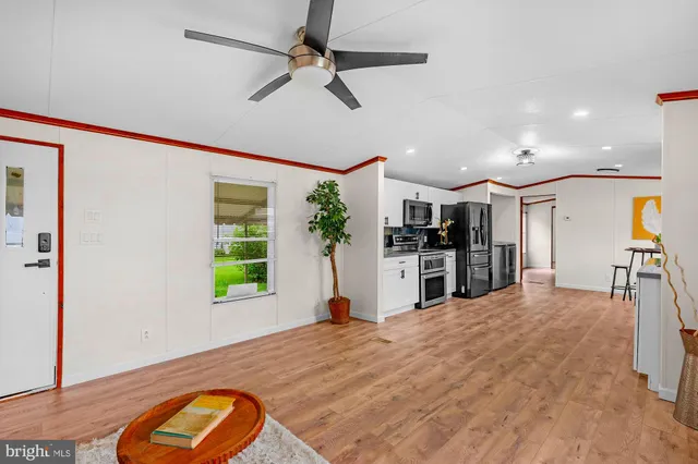 a view of a living room and kitchen with a flat screen tv