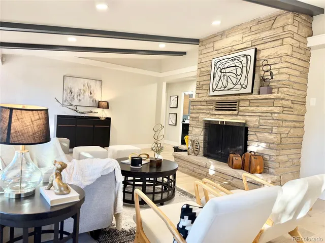 a living room with furniture a flat screen tv and a fireplace