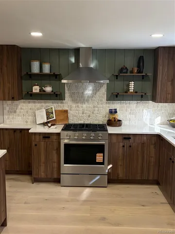 a kitchen with stainless steel appliances granite countertop a stove a sink and a microwave