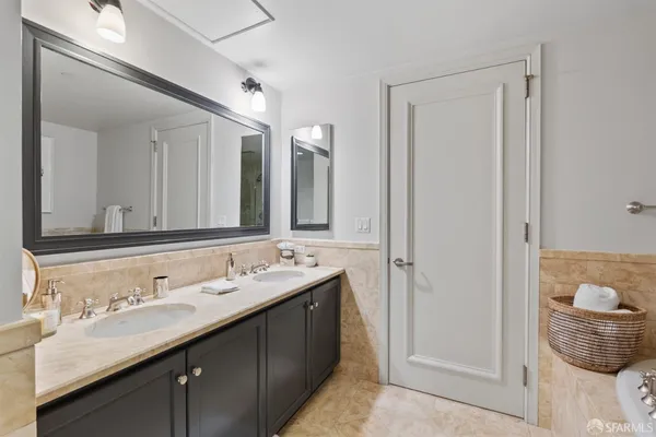 a bathroom with a tub sink and mirror