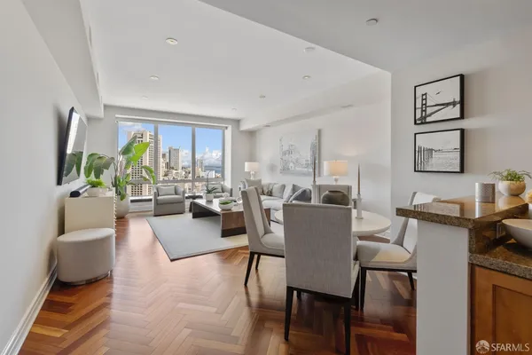 a view of a dining room with furniture and a potted plant