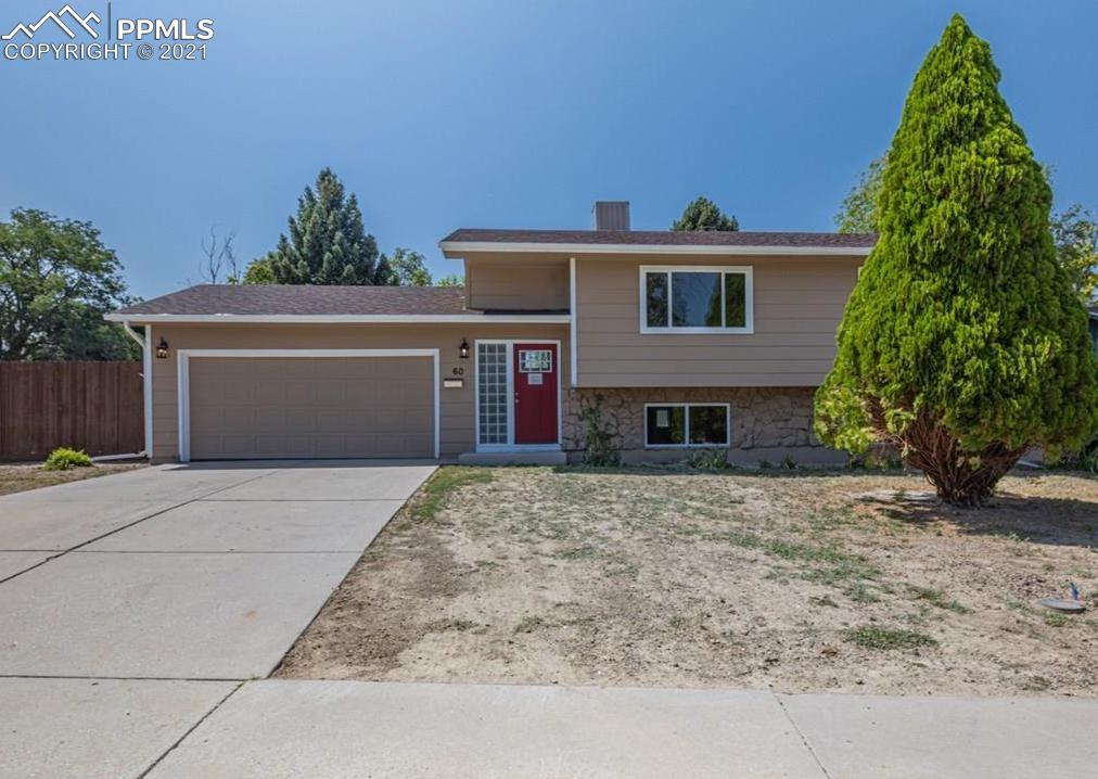 60 Calhoun Road Pueblo, CO 81001 - Photo 1 of 32 a front view of a house with a yard and garage