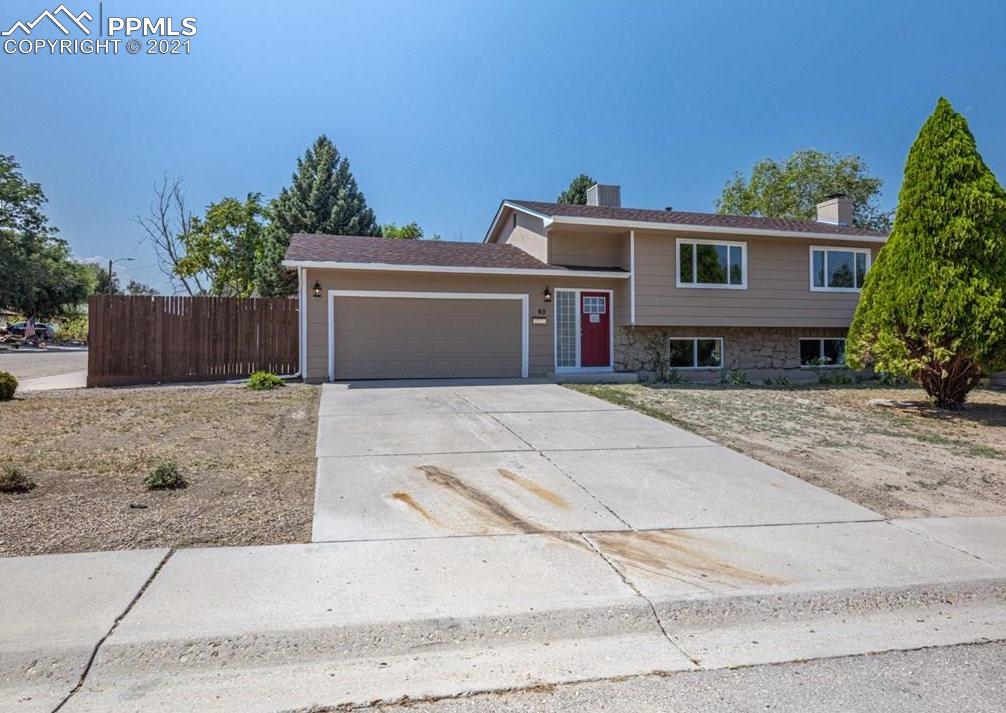 60 Calhoun Road Pueblo, CO 81001 - Photo 2 of 32 a front view of a house with a yard and a garage