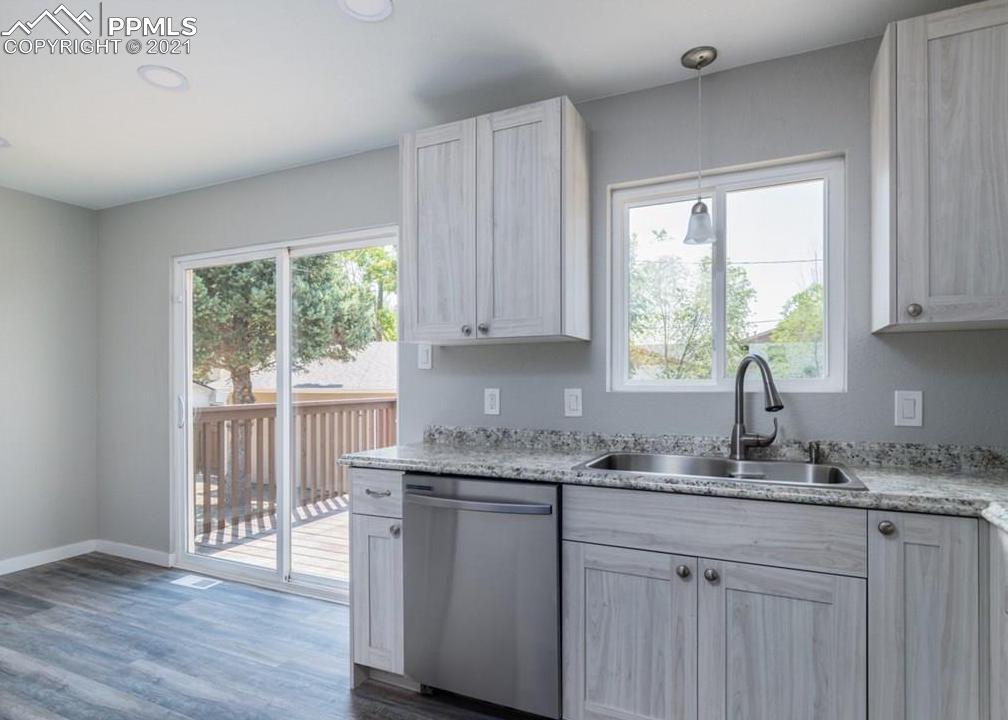 60 Calhoun Road Pueblo, CO 81001 - Photo 11 of 32 a kitchen with stainless steel appliances granite countertop wooden floors and white cabinets