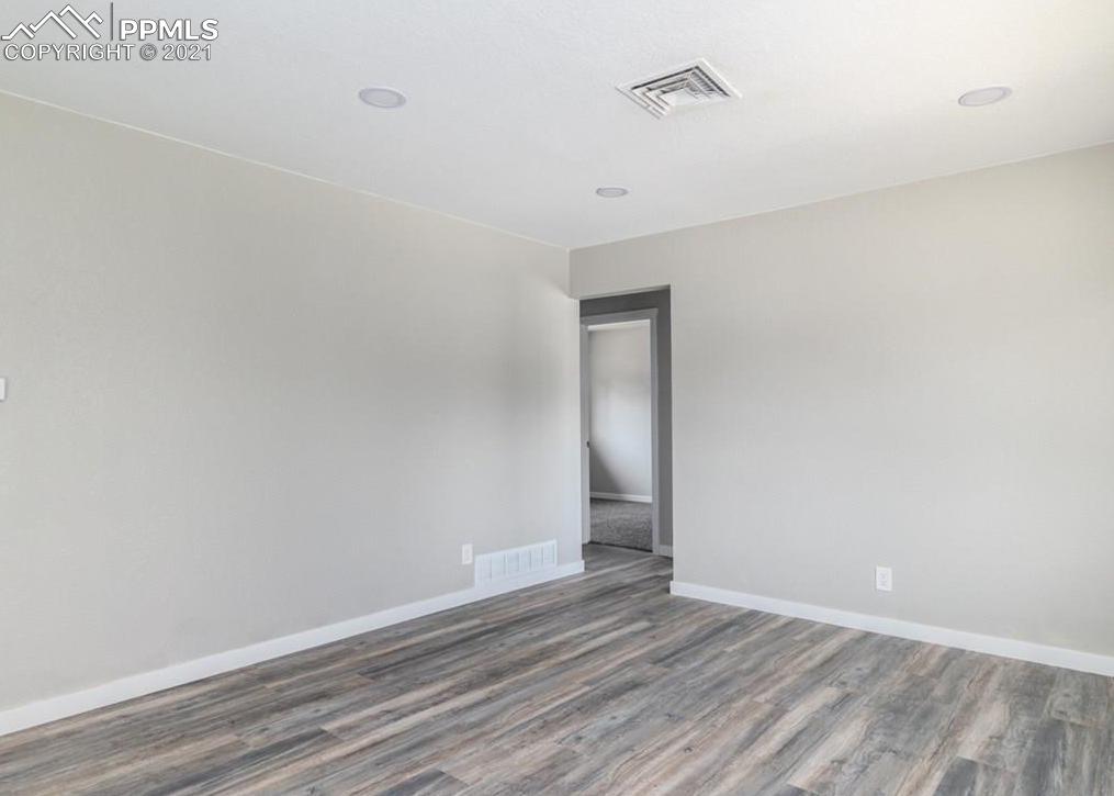 60 Calhoun Road Pueblo, CO 81001 - Photo 14 of 32 a view of an empty room with wooden floor