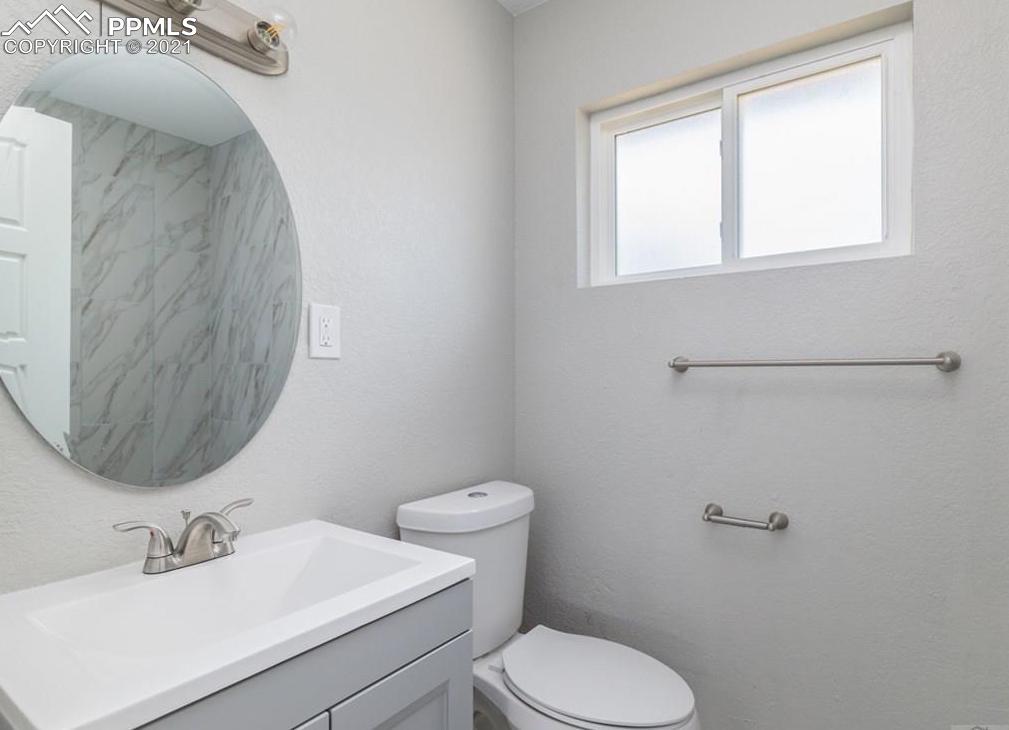 60 Calhoun Road Pueblo, CO 81001 - Photo 17 of 32 a bathroom with a toilet sink and mirror