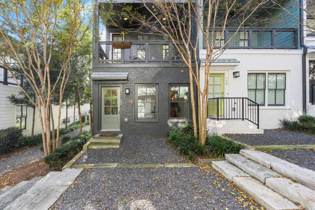 a front view of a house with garden