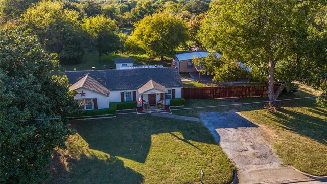 a front view of a house with yard patio and green space