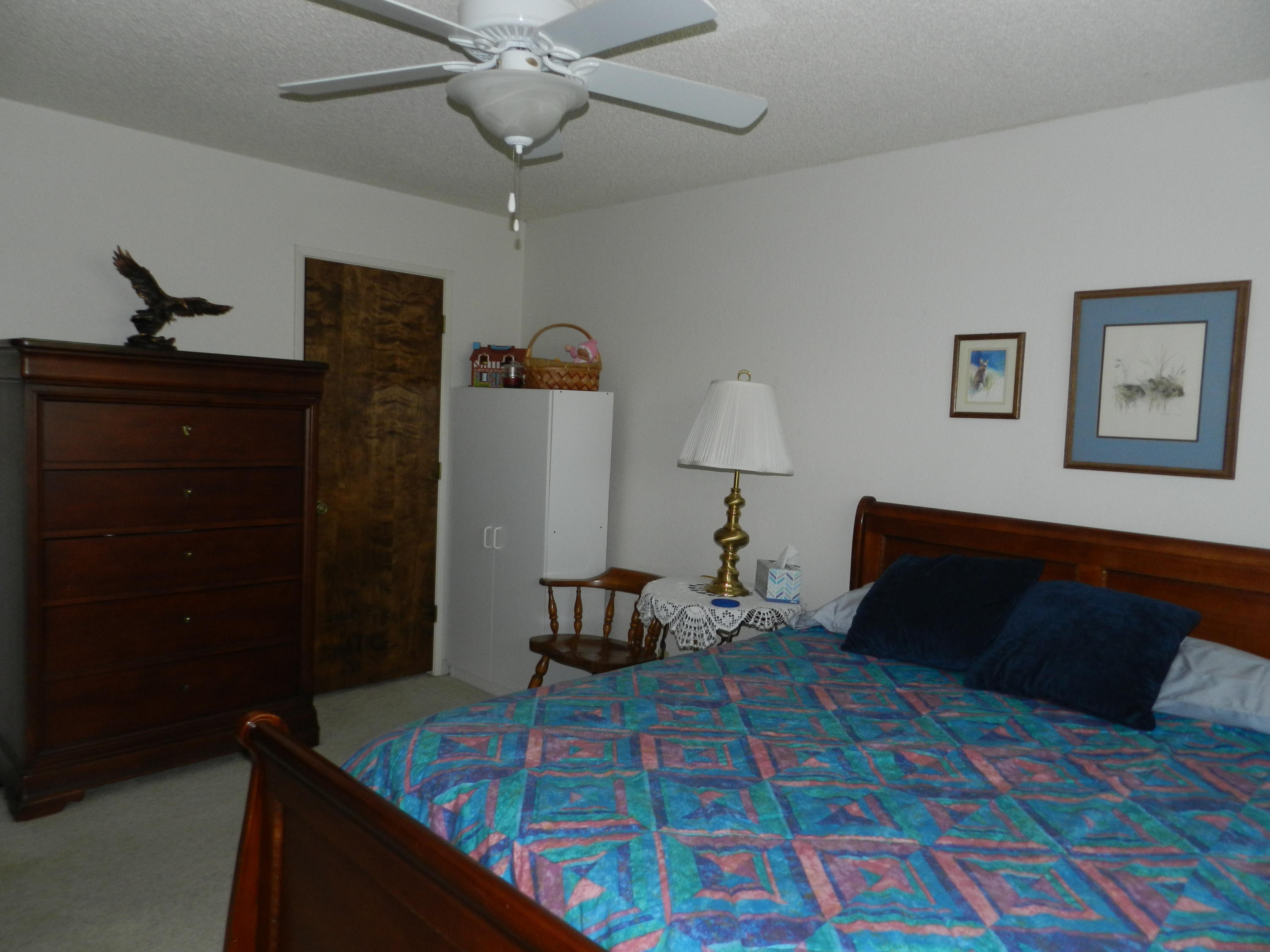 8760 Valley View Road Redding, CA 96001 - Photo 14 of 42 a bedroom with a bed and wooden floor