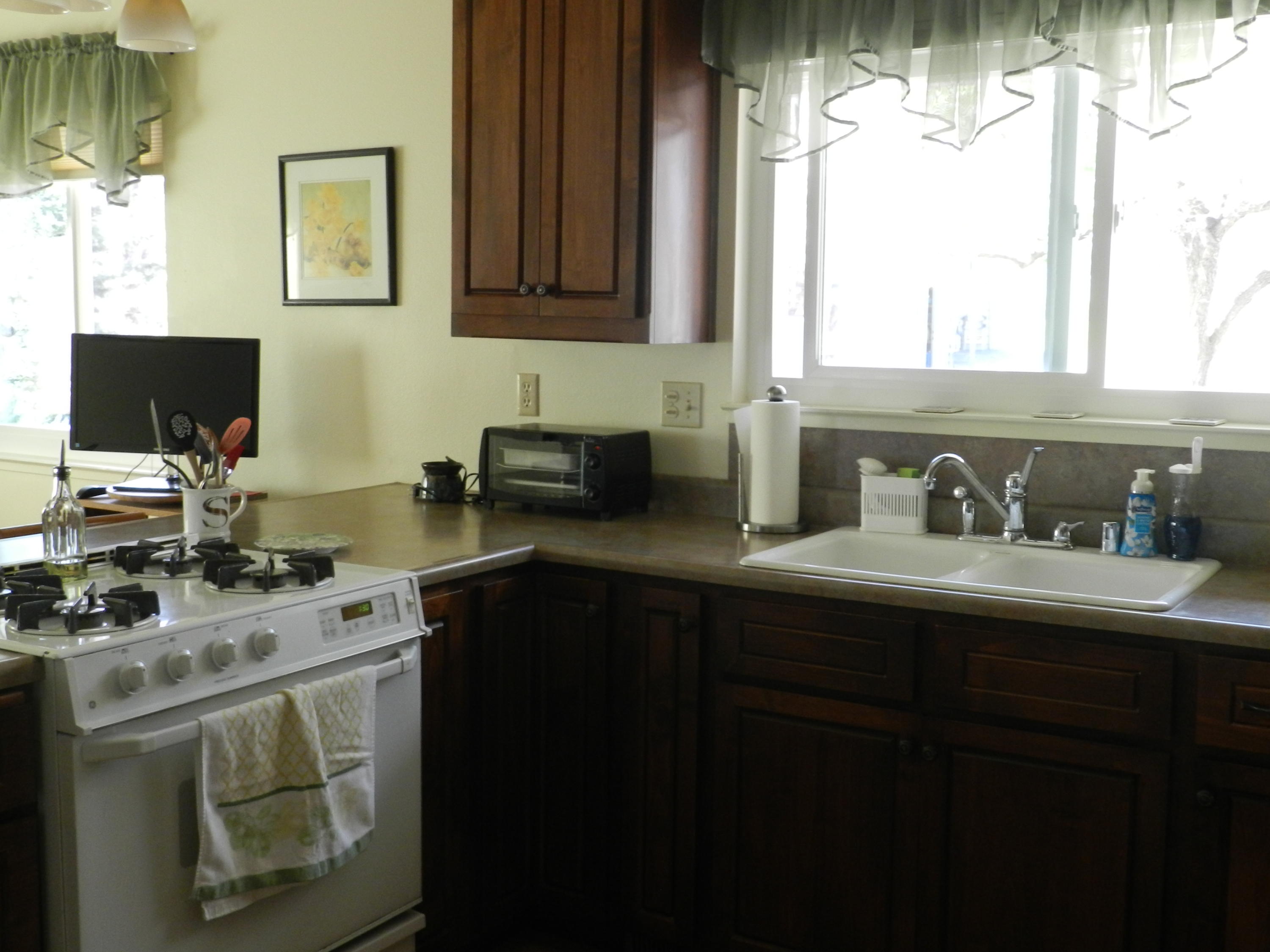8760 Valley View Road Redding, CA 96001 - Photo 20 of 42 a kitchen with a sink stove and cabinets