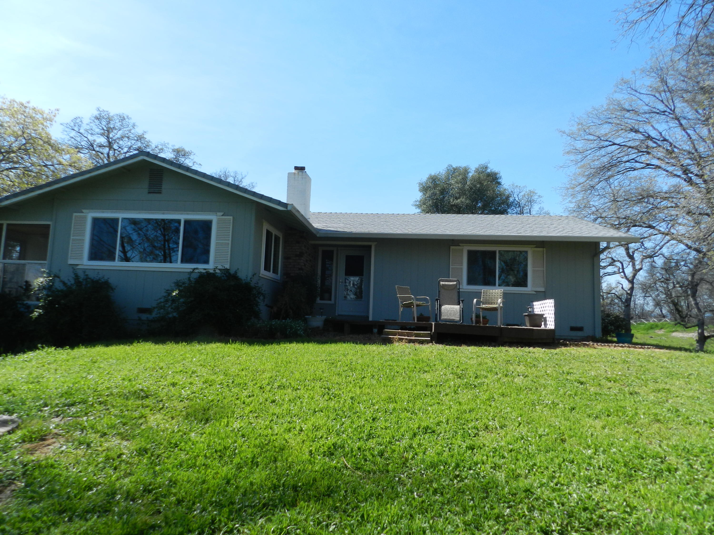 8760 Valley View Road Redding, CA 96001 - Photo 24 of 42 a front view of a house with a yard and trees