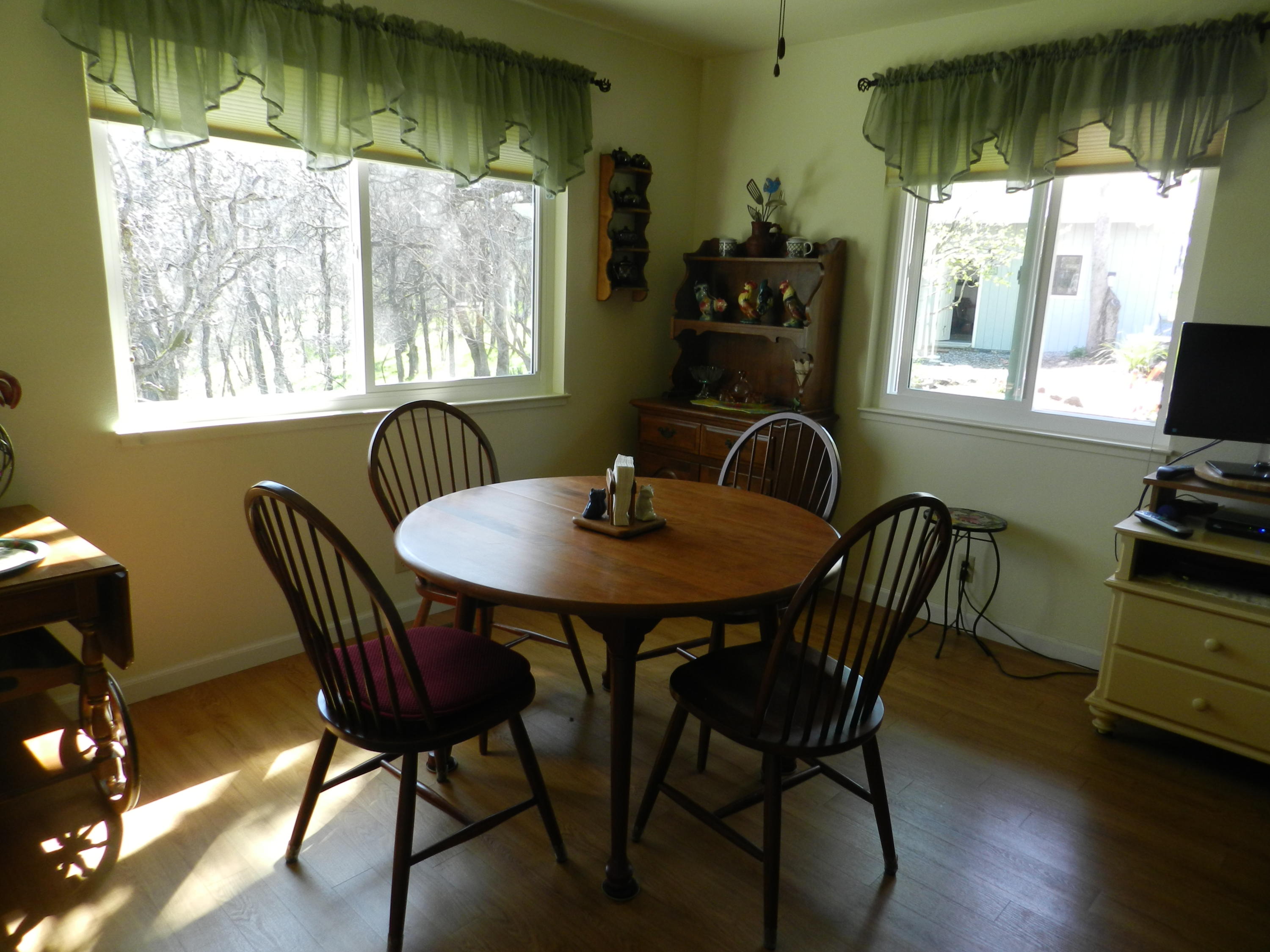 8760 Valley View Road Redding, CA 96001 - Photo 5 of 42 a dining room with furniture window wooden floor