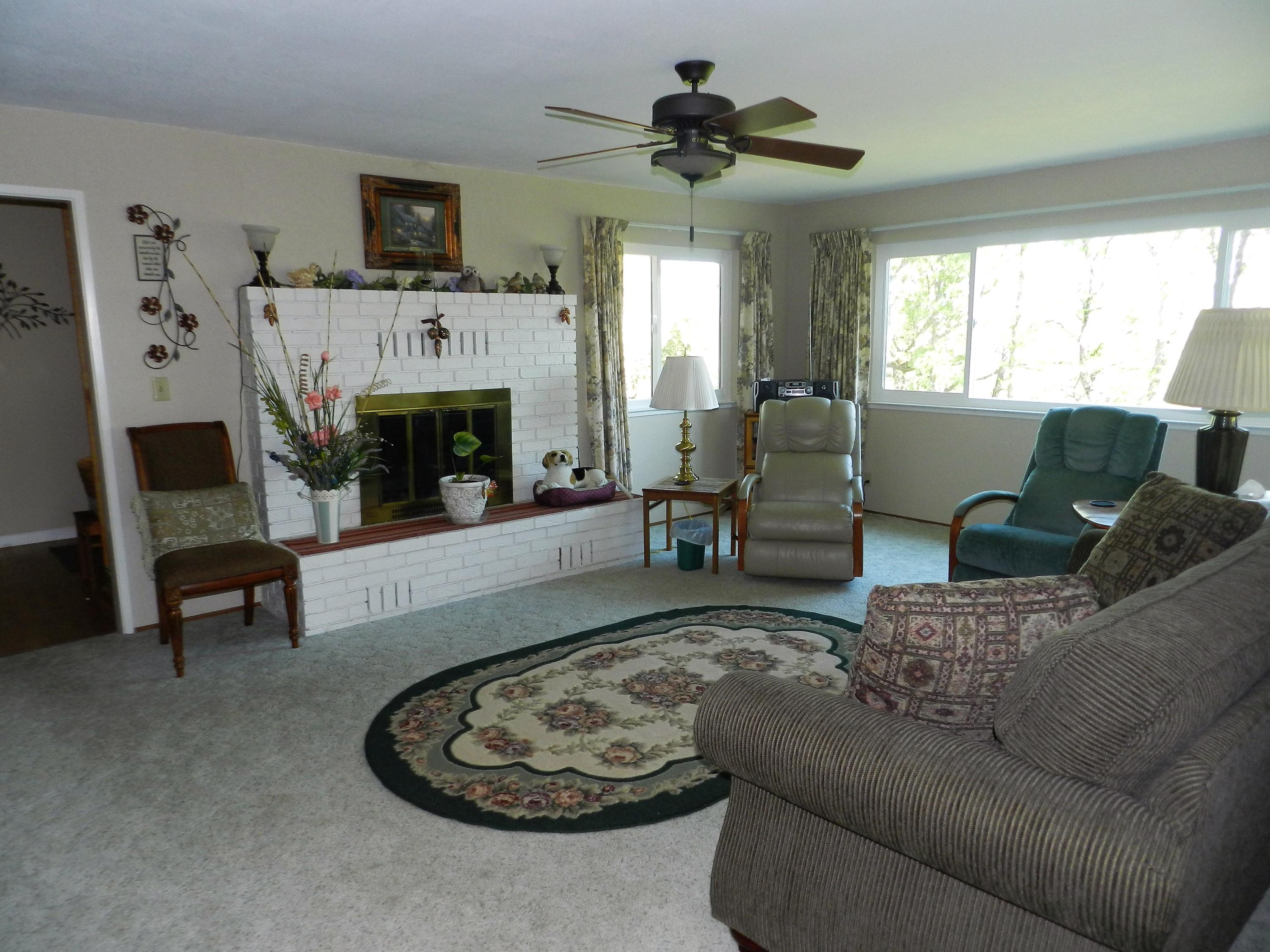 8760 Valley View Road Redding, CA 96001 - Photo 9 of 42 a living room with furniture a window and a fireplace