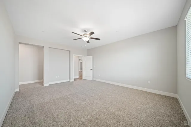 a view of an empty room with a fan