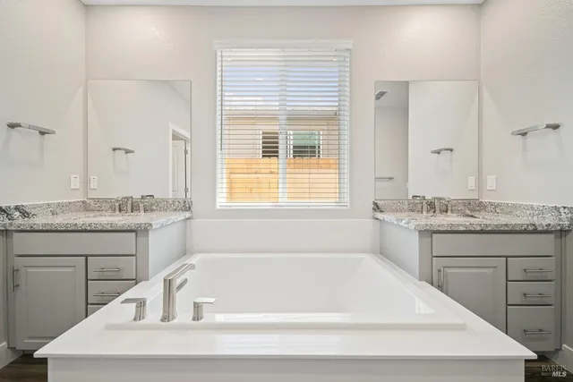 a white bath tub sitting next to a window