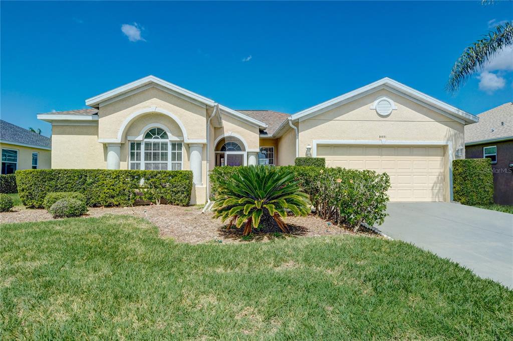 a view of a house with a small yard and plants