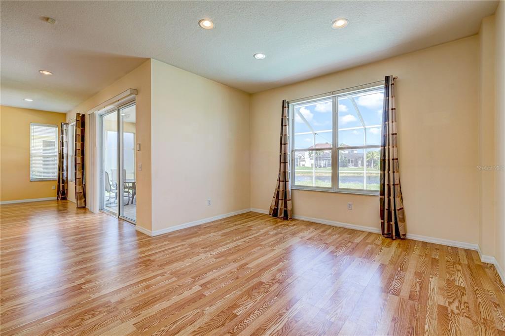 5621 52nd Avenue West Bradenton, FL 34210 - Photo 12 of 33 a view of an empty room with wooden floor and a window