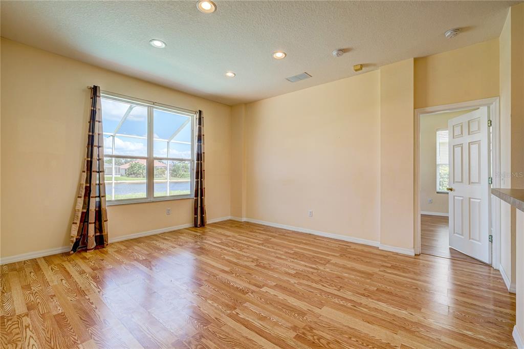 5621 52nd Avenue West Bradenton, FL 34210 - Photo 13 of 33 wooden floor in an empty room with a window