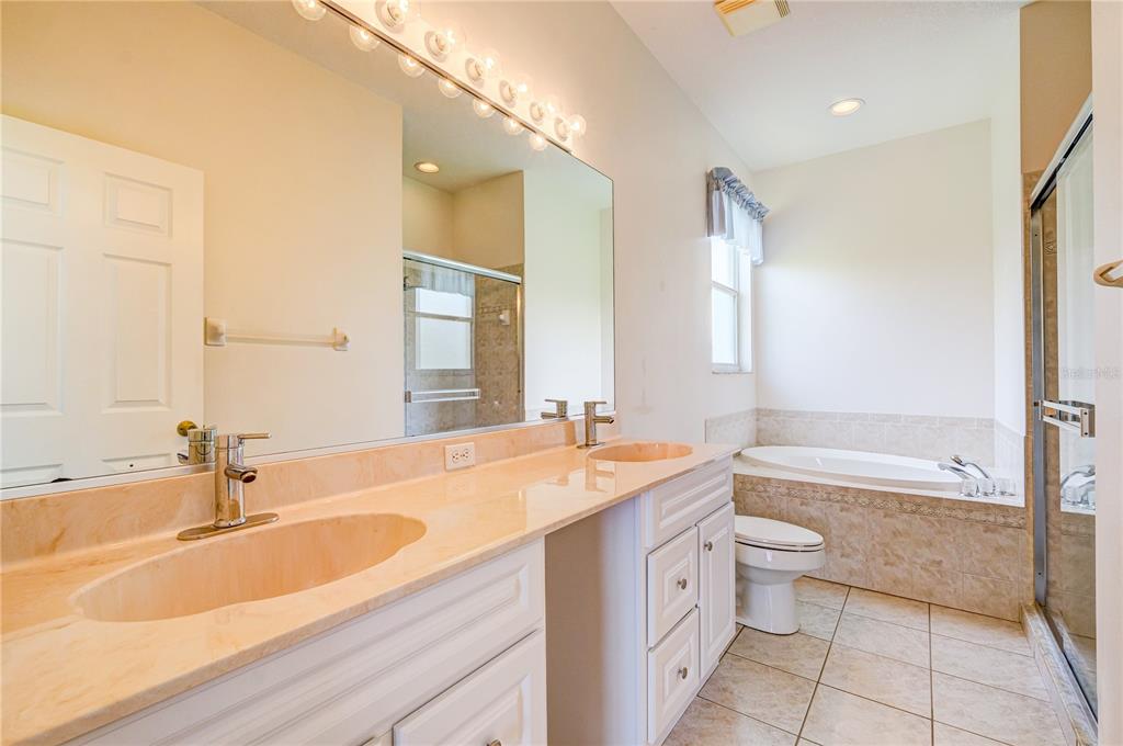 5621 52nd Avenue West Bradenton, FL 34210 - Photo 17 of 33 a bathroom with a granite countertop sink and a bathtub