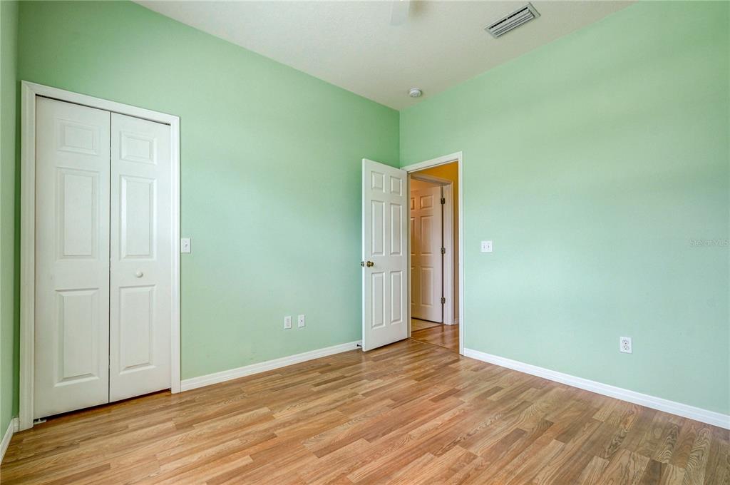 5621 52nd Avenue West Bradenton, FL 34210 - Photo 20 of 33 an empty room with wooden floor and closet
