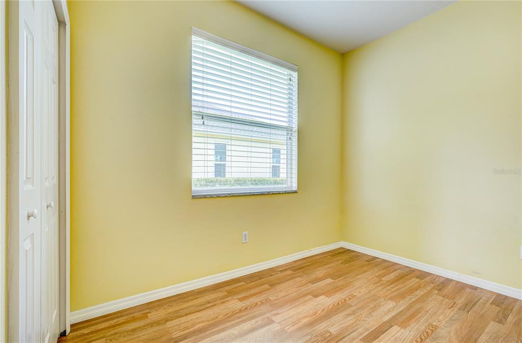5621 52nd Avenue West Bradenton, FL 34210 - Photo 23 of 33 a view of an empty room with wooden floor and a window