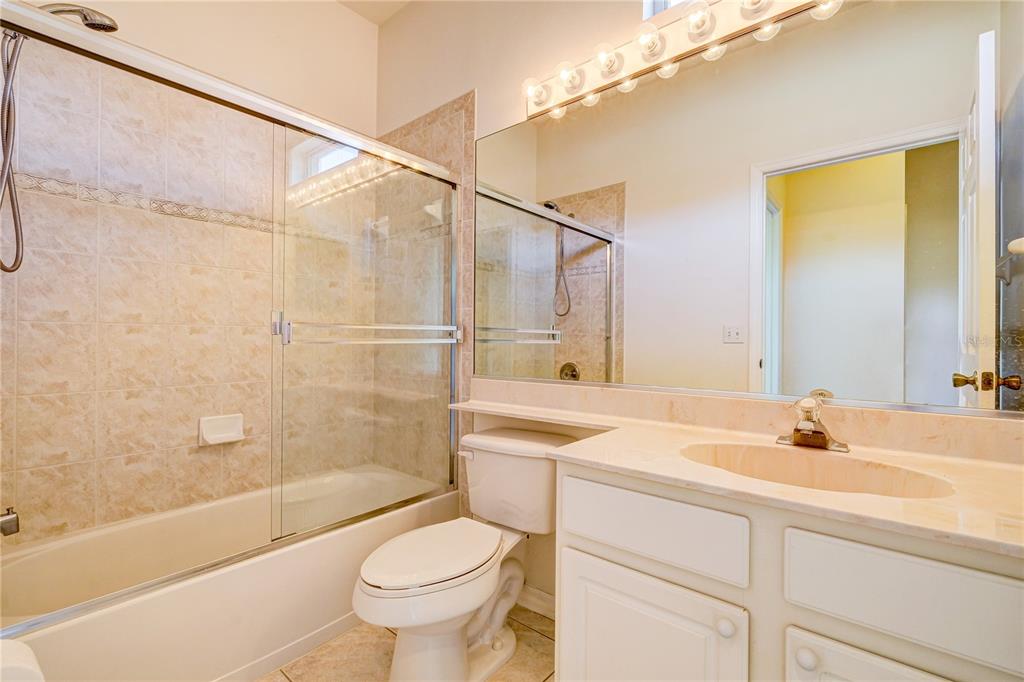 5621 52nd Avenue West Bradenton, FL 34210 - Photo 25 of 33 a bathroom with a sink a toilet and a bathtub