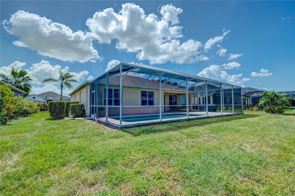 5621 52nd Avenue West Bradenton, FL 34210 - Photo 30 of 33 a view of a house with a backyard