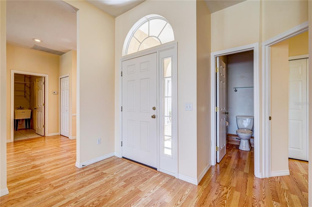 5621 52nd Avenue West Bradenton, FL 34210 - Photo 3 of 33 a view of hallway with bathroom and wooden floor