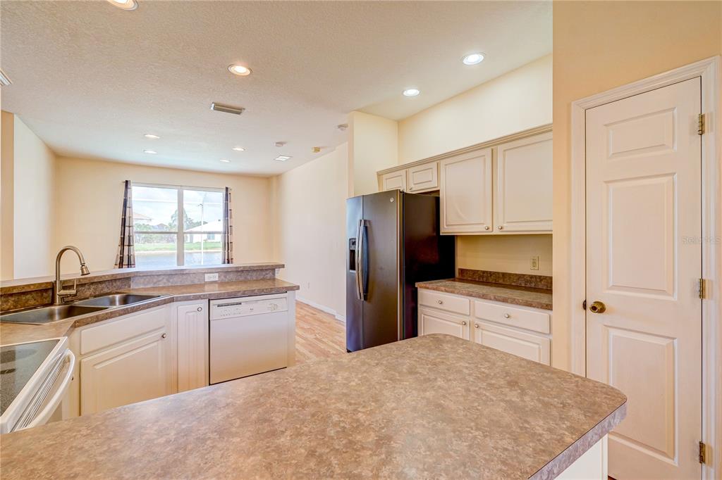 5621 52nd Avenue West Bradenton, FL 34210 - Photo 4 of 33 a kitchen with a refrigerator a sink and cabinets