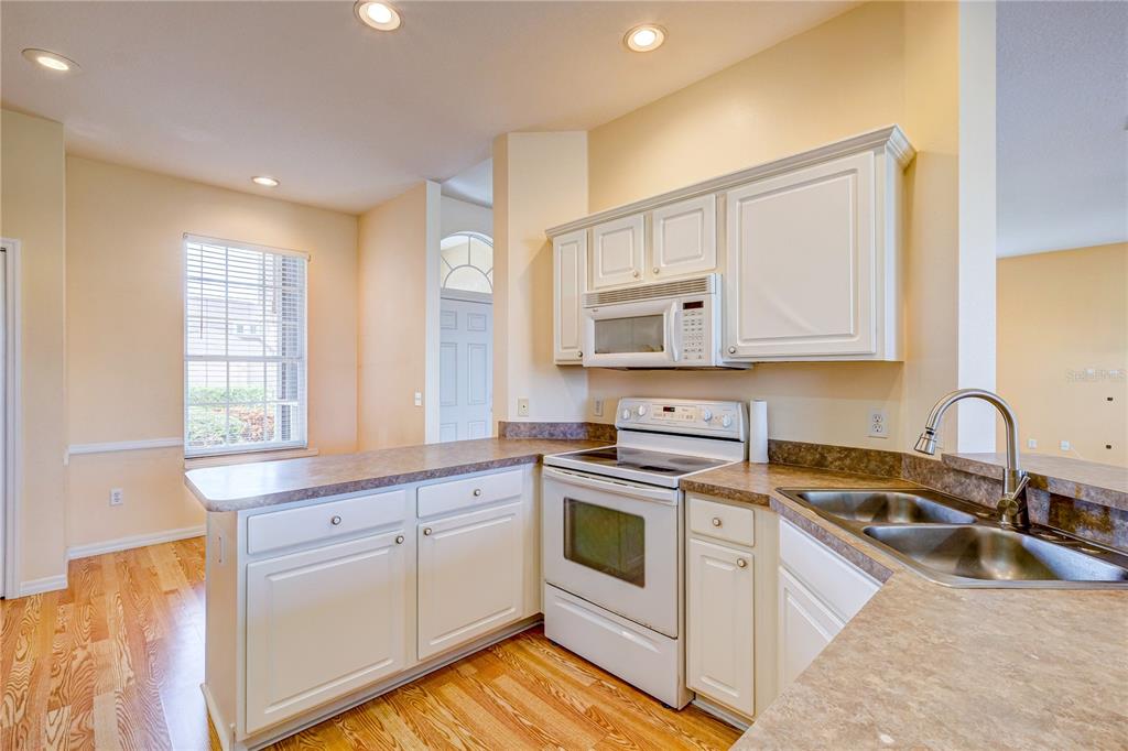 5621 52nd Avenue West Bradenton, FL 34210 - Photo 8 of 33 a kitchen with white cabinets sink and appliances