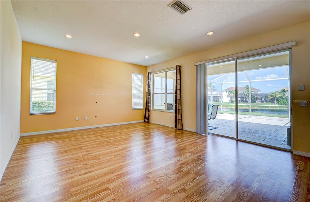 5621 52nd Avenue West Bradenton, FL 34210 - Photo 10 of 33 a view of an empty room with wooden floor and a window