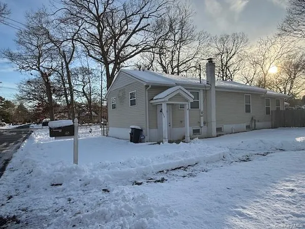 a view of a house with a yard covered in snow