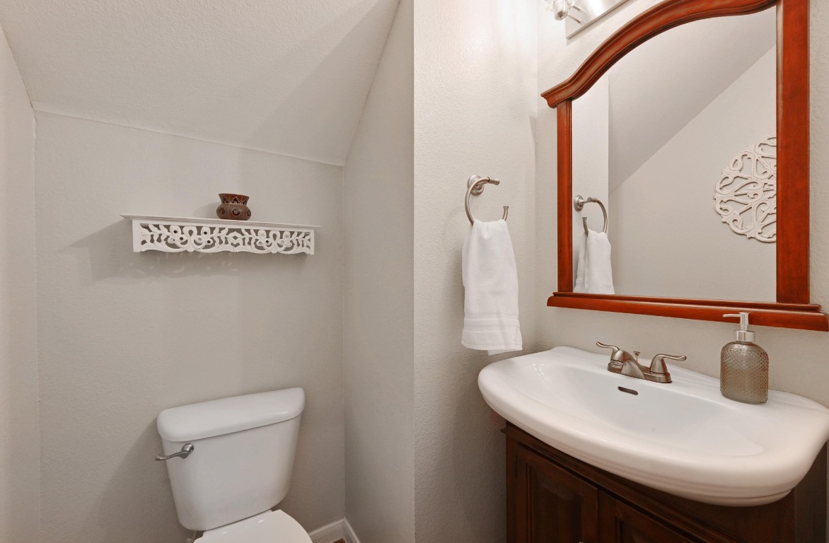 400 Tobin Drive Buda, TX 78610 - Photo 17 of 40 Half bathroom with vanity and lofted ceiling