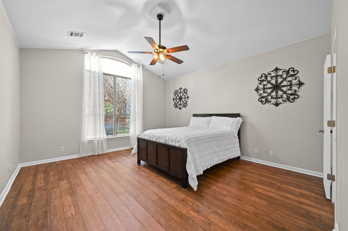400 Tobin Drive Buda, TX 78610 - Photo 19 of 40 Bedroom featuring a ceiling fan, wood like floors, and vaulted ceiling
