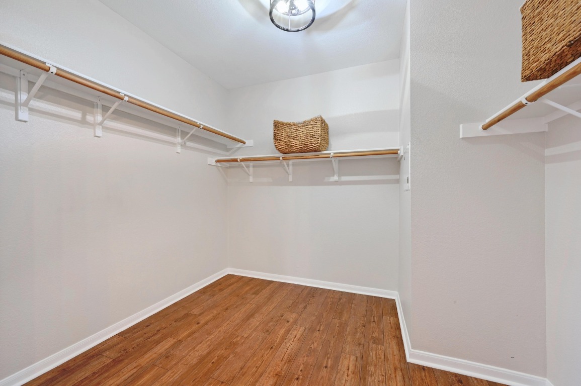 400 Tobin Drive Buda, TX 78610 - Photo 22 of 40 Primary walk in closet featuring wood like floors