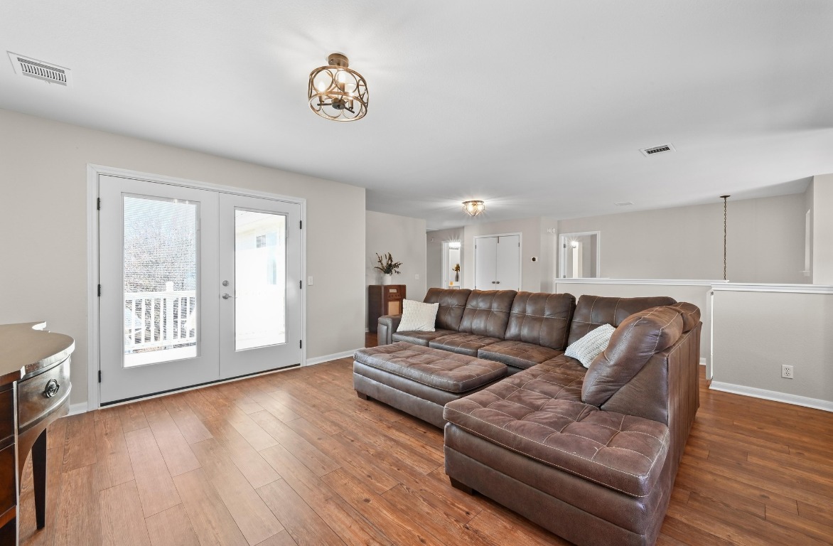 400 Tobin Drive Buda, TX 78610 - Photo 23 of 40 Living area upstairs featuring wood-type flooring and French doors leading to one of two balcony's