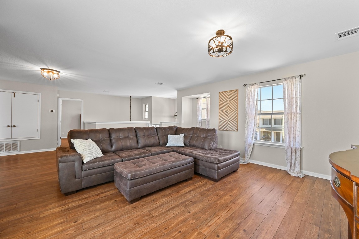 400 Tobin Drive Buda, TX 78610 - Photo 24 of 40 Living area with wood-type flooring and a chandelier