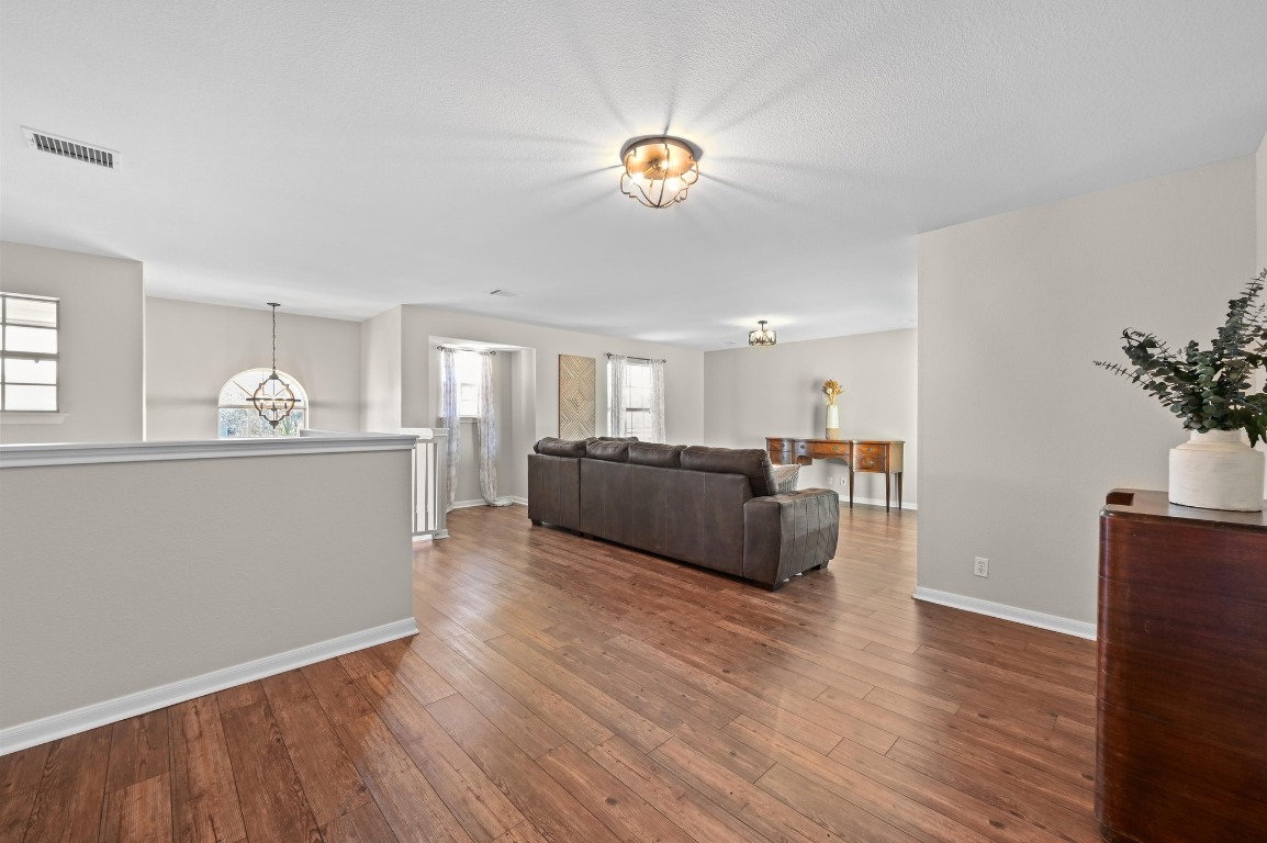 400 Tobin Drive Buda, TX 78610 - Photo 25 of 40 Living room with a chandelier and dark wood-style floors