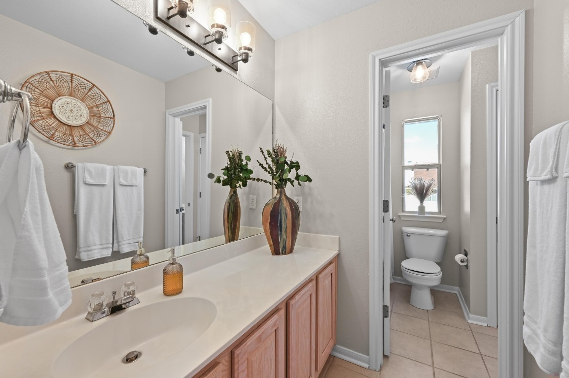 400 Tobin Drive Buda, TX 78610 - Photo 32 of 40 Jack and Jill bathroom featuring vanity and light tile patterned floors