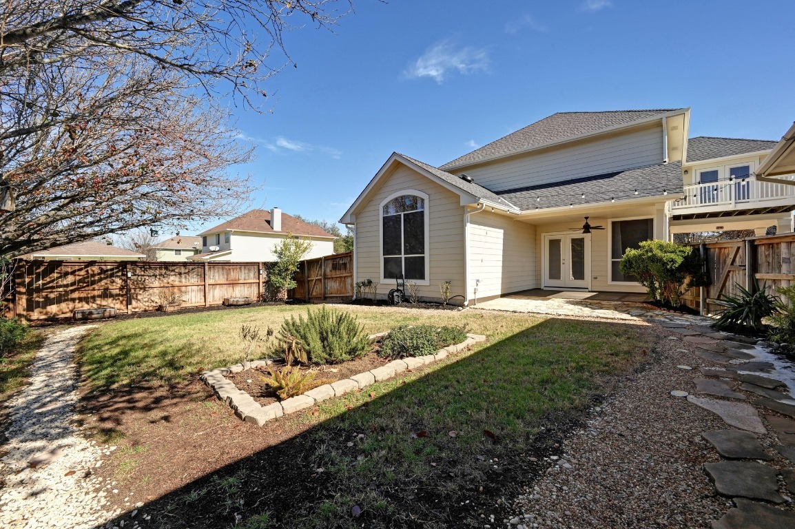 400 Tobin Drive Buda, TX 78610 - Photo 35 of 40 Rear view of house featuring ceiling fan, a patio area, a fenced backyard, and a shingled roof