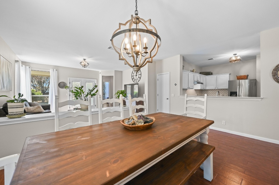 400 Tobin Drive Buda, TX 78610 - Photo 9 of 40 Dining area with dark wood-type flooring and a chandelier