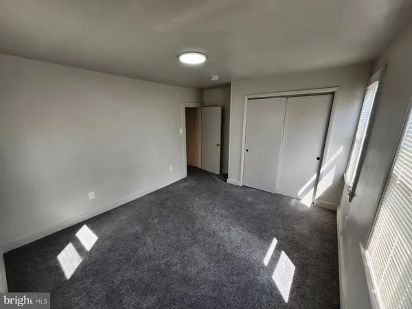 a view of an empty room and a window