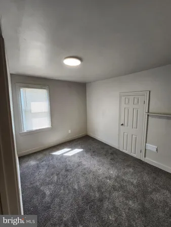 an empty room with a empty space and a window