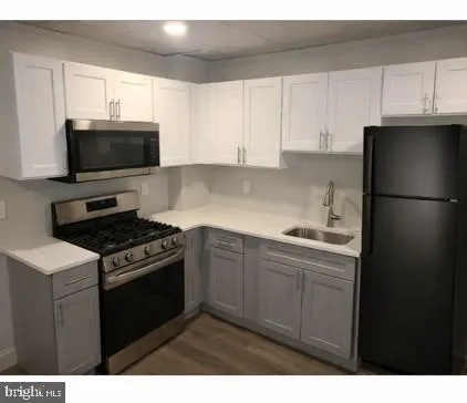a kitchen with a sink stove and refrigerator