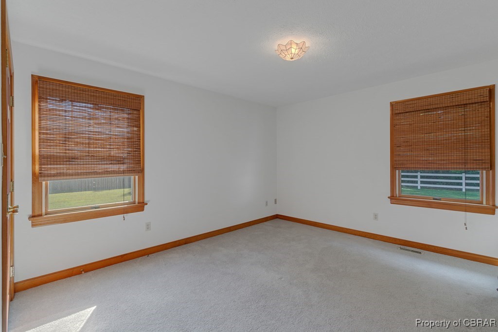 35 Powhatan Road Kilmarnock, VA 22482 - Photo 31 of 42 Unfurnished room with carpet flooring, baseboards, and visible vents